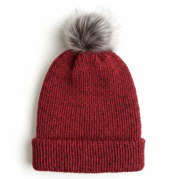 Burgundy knit hat with a fluffy gray pompom on a white background.