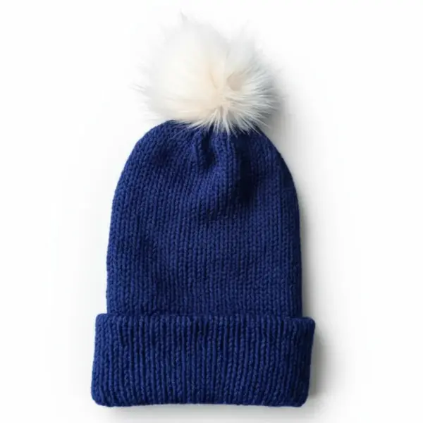 Dark blue knitted wool hat with a white pom-pom on a white background