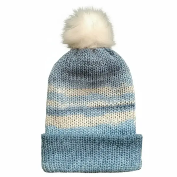 Light blue knit hat with white pom-pom on a white background, featuring cream and blue gradient stripes.