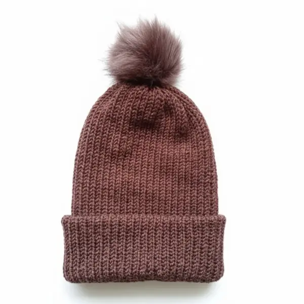 brown knitted beanie hat with pom pom on white background, cozy winter accessory flatlay
